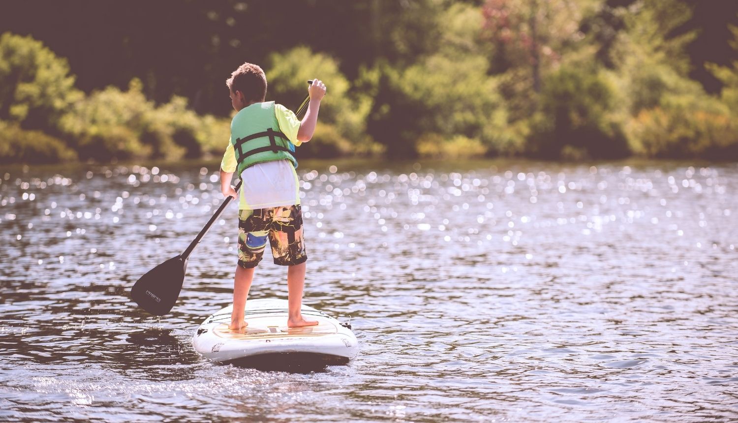 Young boy paddle boarding 